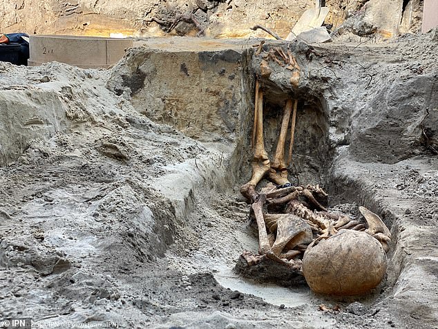 Notorious for its torture chambers and the numerous executions carried out in a special death bunker, the bodies were then buried in the grounds and trees planted to cover up the mass graves. Above: One of the newly-discovered bodies