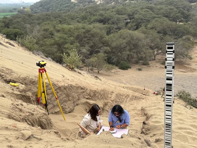 Archaeologists meticulously uncover what appear to be remnants of a 4,000-year-old ceremonial temple buried beneath a sand dune in Lambayeque, northern Peru, on June 27, 2024. (Credit: Peru's Pontifical Catholic University/Handout via REUTERS)