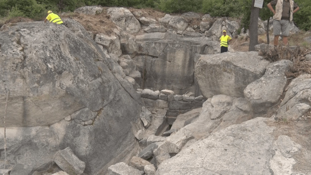 Archaeologists investigating the recently discovered Nymphaeum at Perperikon, revealing its unique architectural features and historical significance. Credit: BTA.