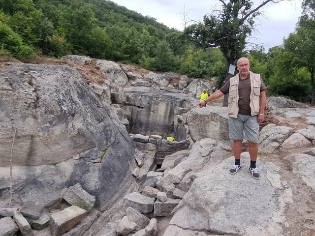 Professor Nikolay Ovcharov proudly presents the recently discovered Nymphaeum at Perperikon, offering a fascinating glimpse into ancient history. (Credit: BTA)