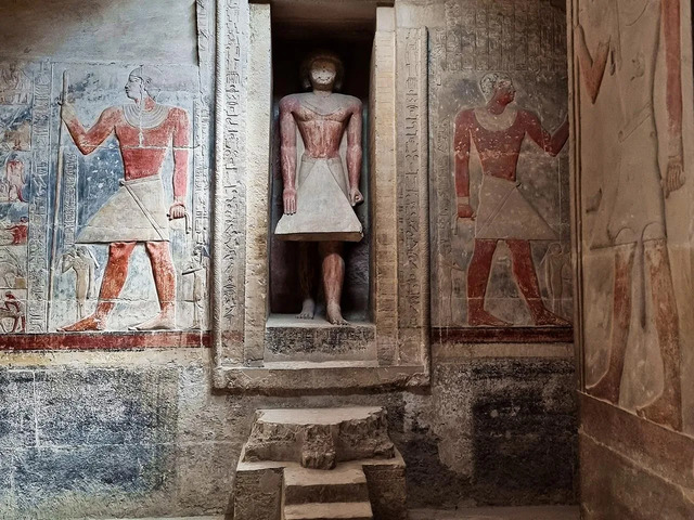 Statues of ancient figures flanking an interior niche within the tomb, symbolizing Tetinebefou’s esteemed status. (Courtesy: Egyptian Ministry of Tourism and Antiquities)