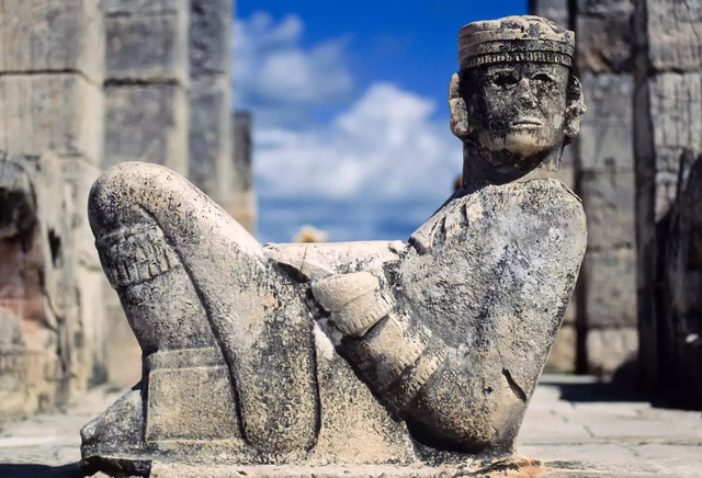 This image shows a prominent Chac Mool statue, a hallmark of Mesoamerican archaeology, located in the Temple of Warriors at Chichen Itza, Yucatan, Mexico.