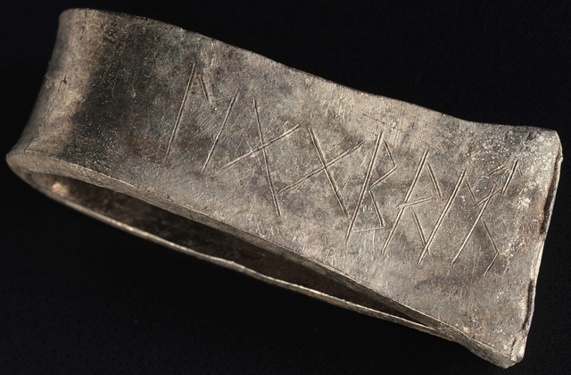 A close-up of a Viking silver arm ring from the Galloway Hoard, featuring runic inscriptions that provide insight into the community’s ownership of the hoard. (Image credit: National Museums Scotland)