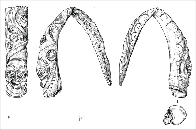 The terminals of this gold-sheet torc display finely rendered Celtic motifs, hinting at a stylized human form.