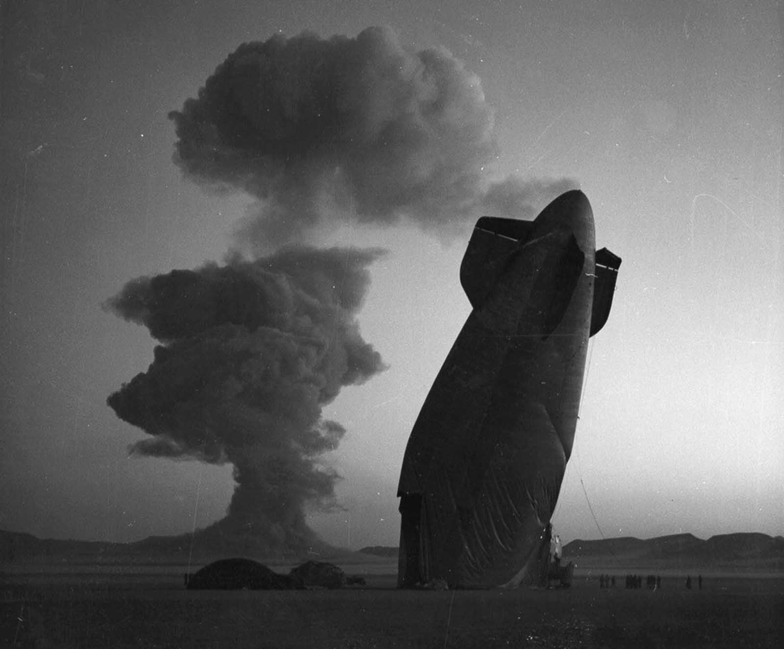 At a Nevada nuclear test site on August 7, 1957, a U.S. Navy blimp was caught in the shockwave of a nuclear explosion. Positioned more than five miles from ground zero, the unmanned airship collapsed upon impact, though personnel in the area remained unharmed.