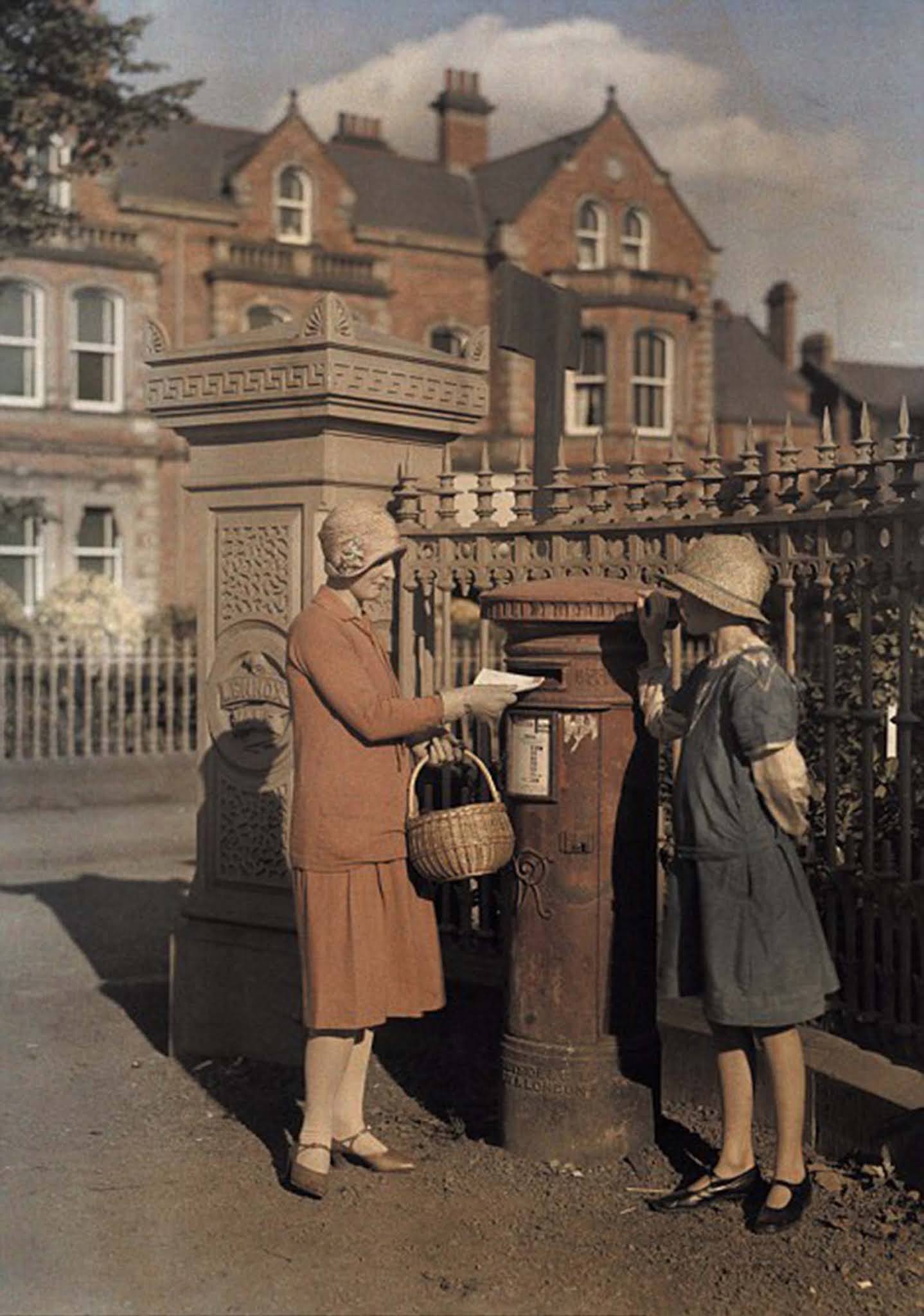 A Childhood Memory in Belfast – Two young girls drop a letter into a red pillar box in Belfast in 1927.