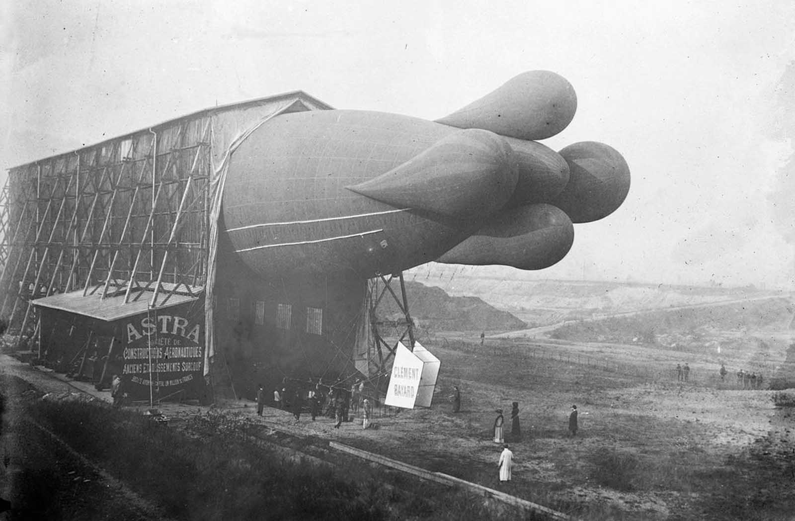 A Clement-Bayard dirigible inside its hangar in France, circa 1908. The stabilizing tail lobes, later removed, were found to hinder speed.