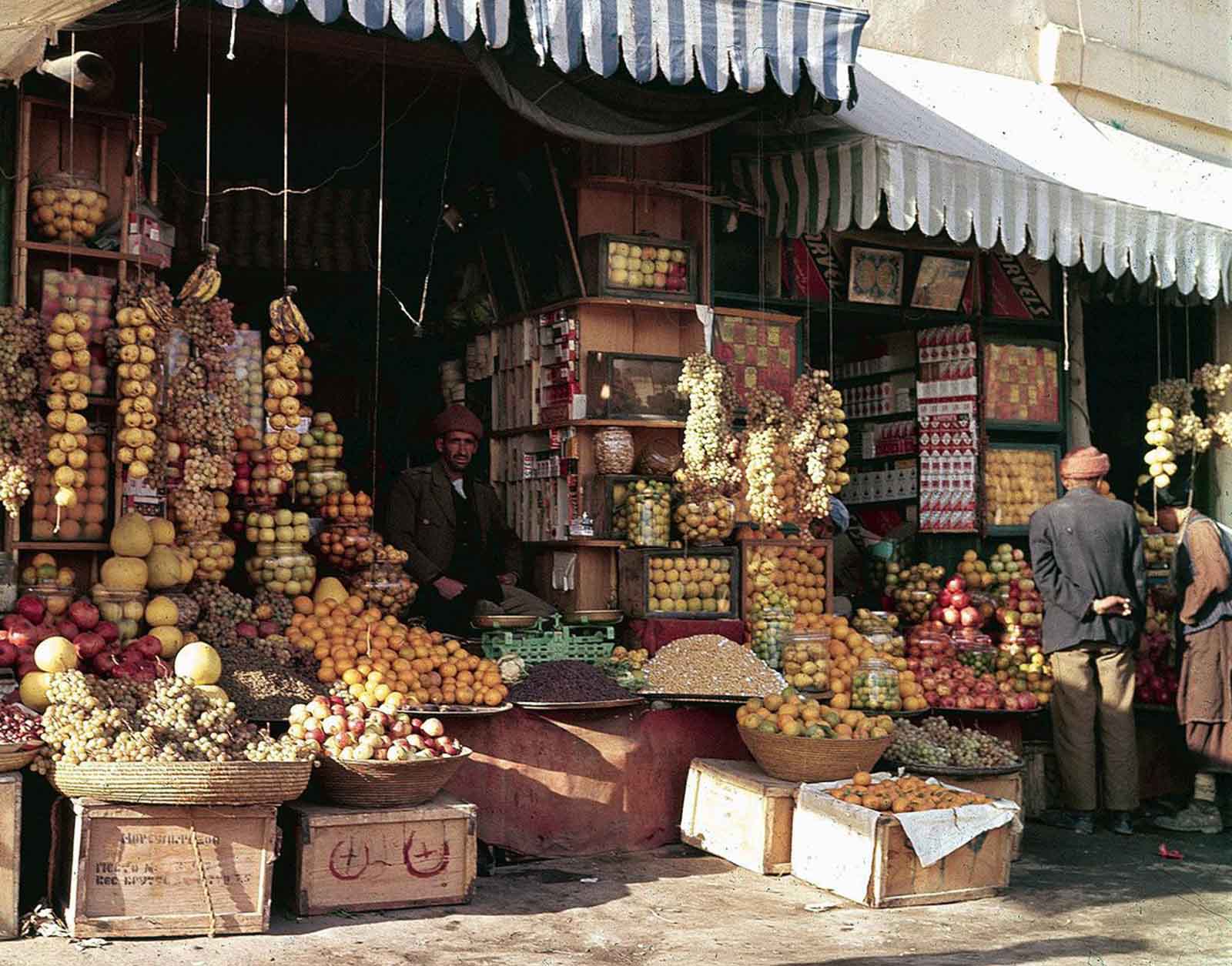 A colorful storefront in Kabul, filled with fresh fruits and nuts, November 1961.