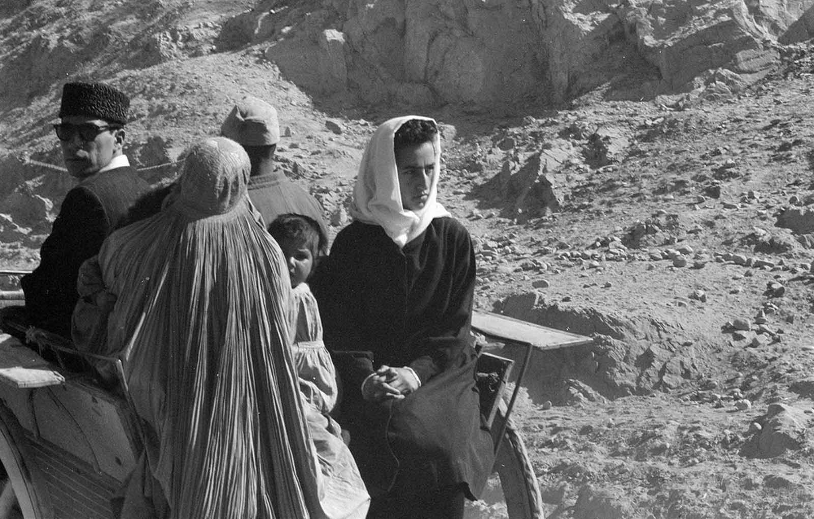 A family journey through the arid Afghan landscape, traveling by cart in November 1959.