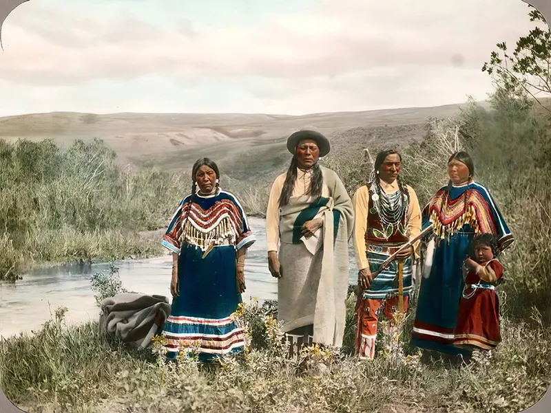 A gathering of Blackfeet men and women, a moment of community and tradition. Montana, early 1900s.
