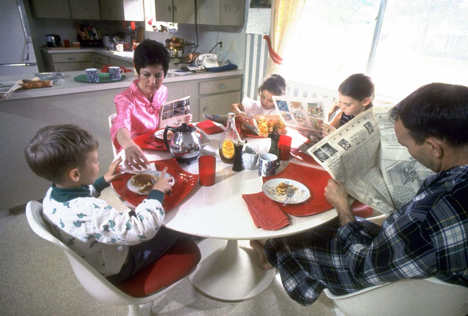 A heartwarming glimpse into astronaut life—Michael Collins, his wife Pat, and their children enjoy a casual pancake breakfast at home, March 1969.