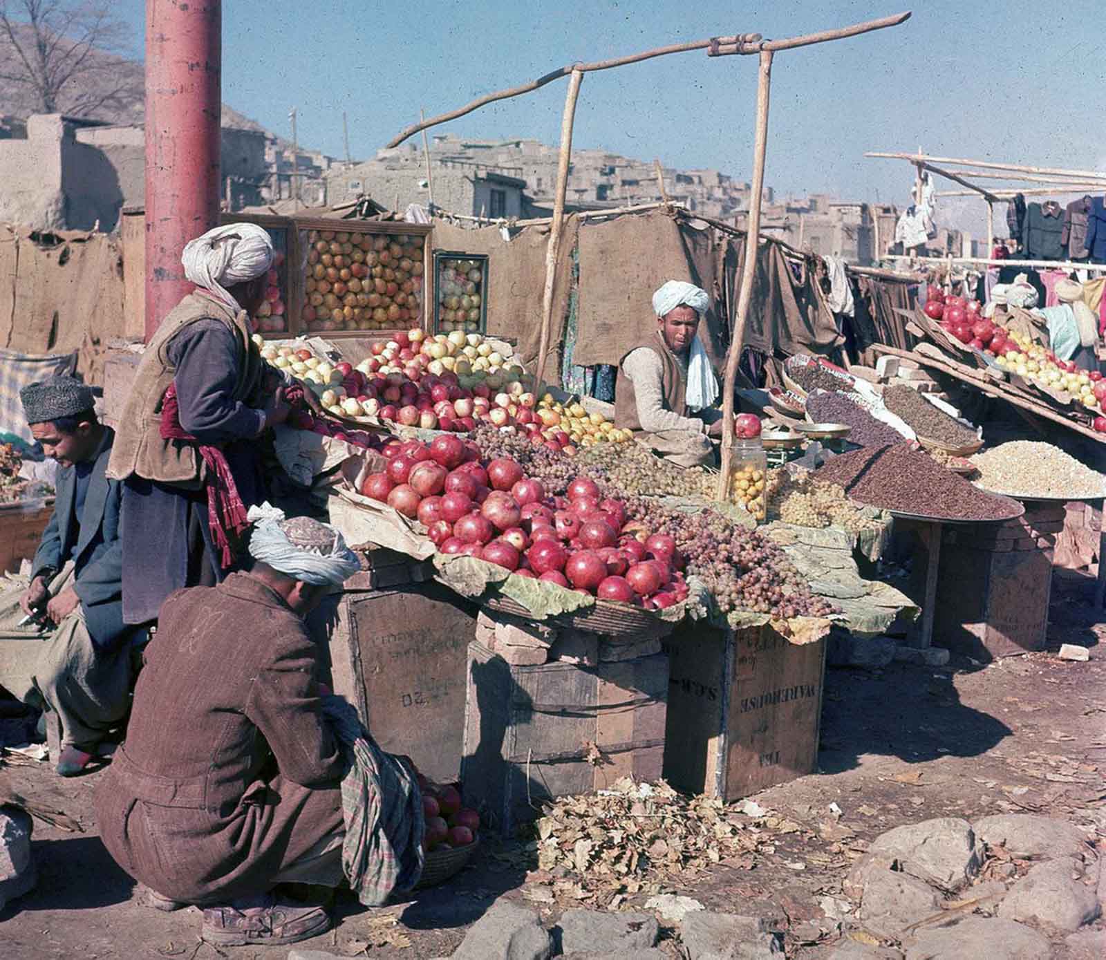 A lively market scene in Kabul, where vendors sell a variety of fruits and nuts, November 1961.