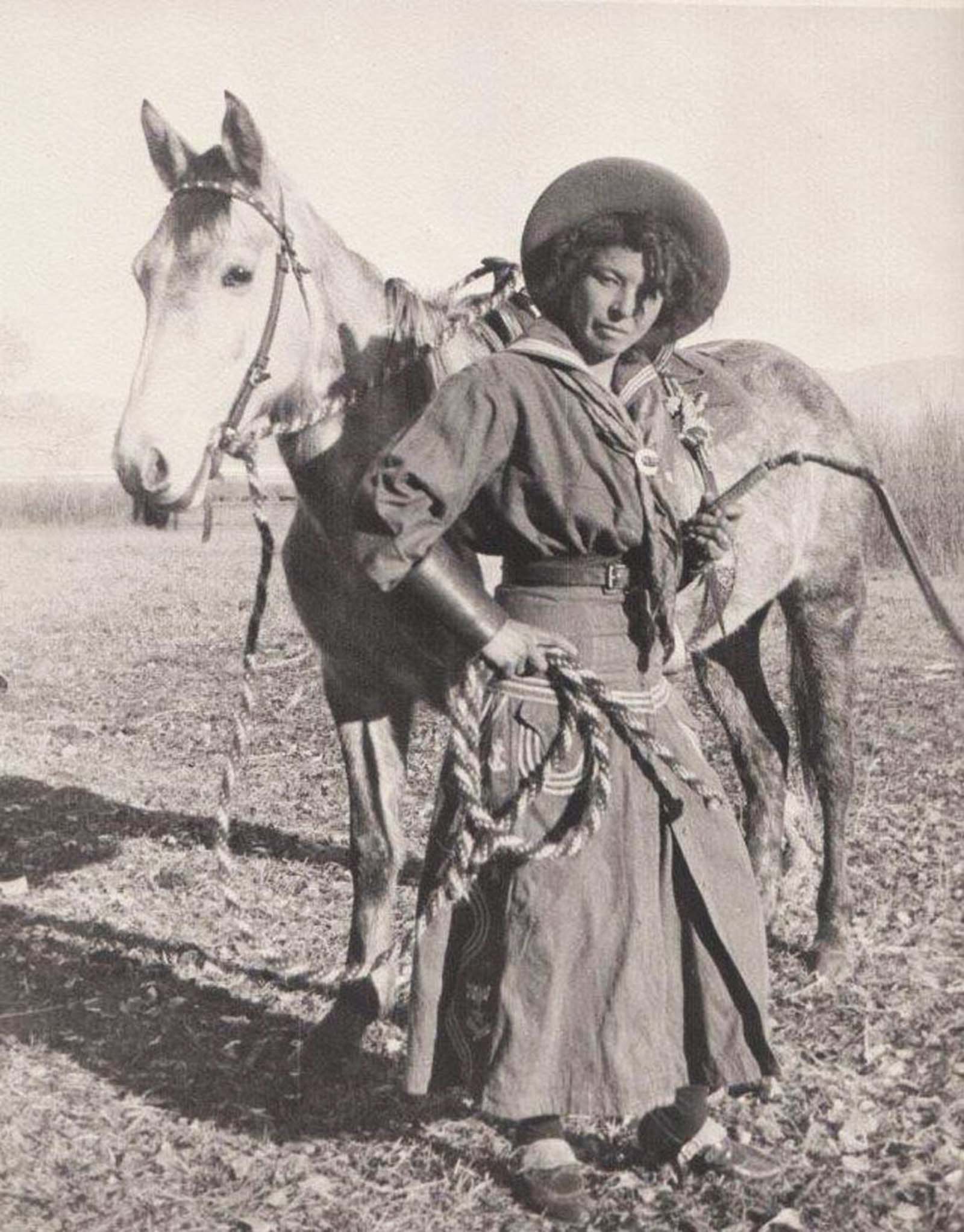 A pioneer on horseback – Nellie Brown, a true cowgirl of the 1880s, embodying the rough and rugged lifestyle of the West.