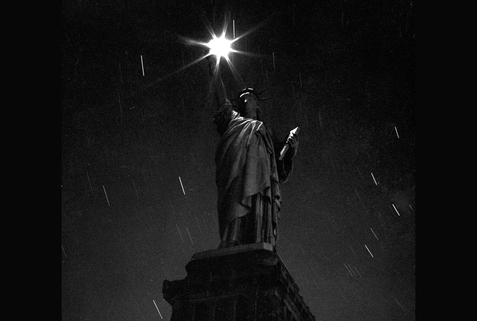 A rare nighttime view of the Statue of Liberty during a World War II blackout in March 1942, part of an effort to conserve energy.