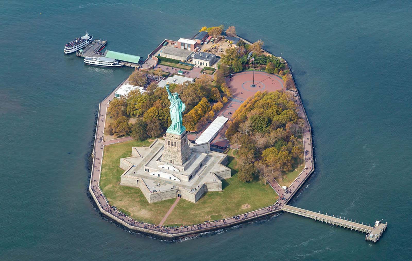 A spectacular aerial view of the Statue of Liberty and Liberty Island, taken in October 2015, showcasing the enduring symbol of freedom from above.