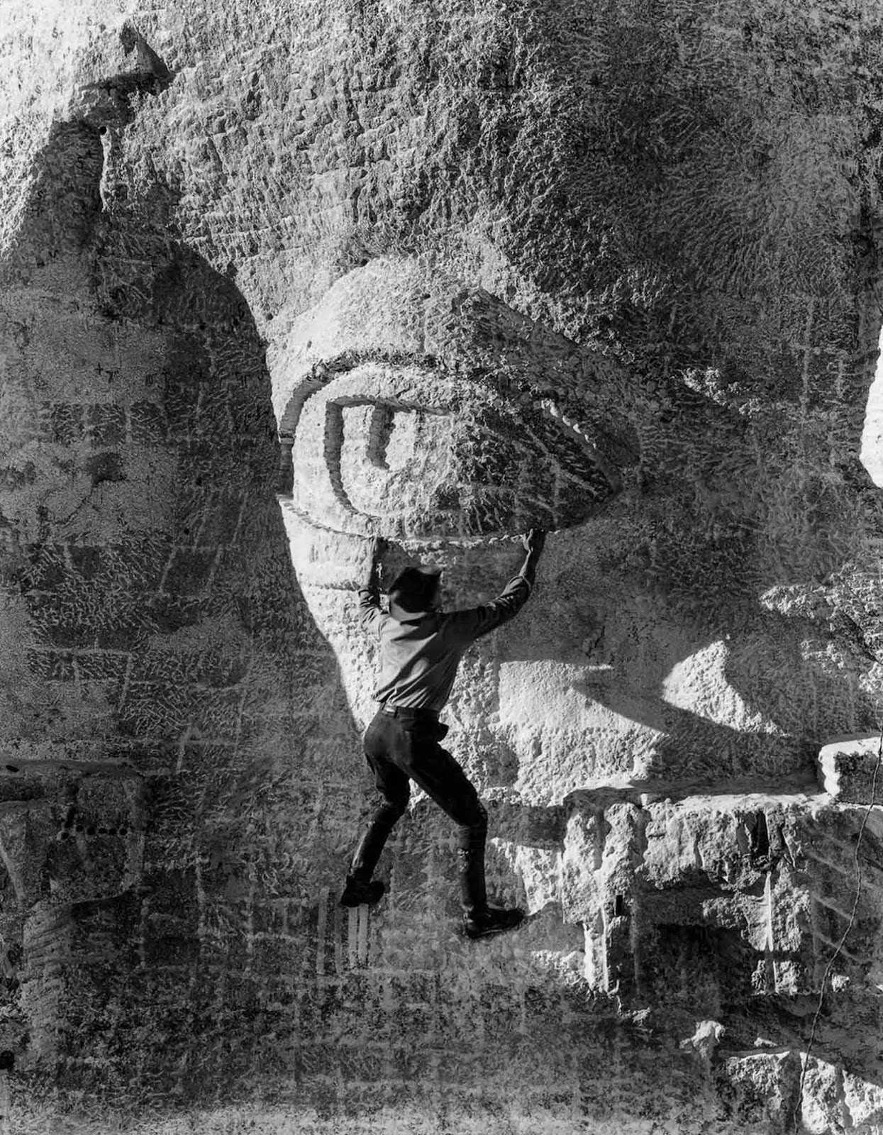A stone carver balances on Thomas Jefferson’s eyelid, 1936.