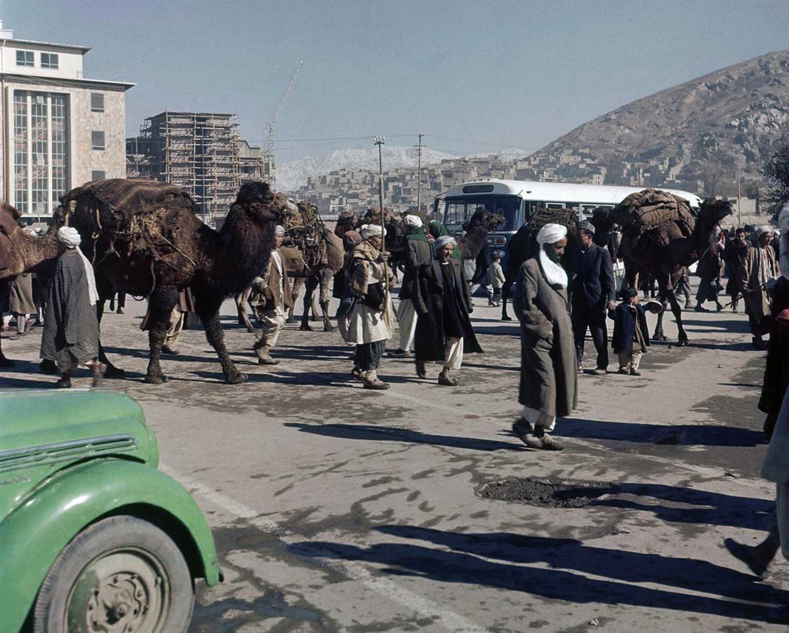 A street scene in Kabul, November 1961, filled with daily life and local interactions.