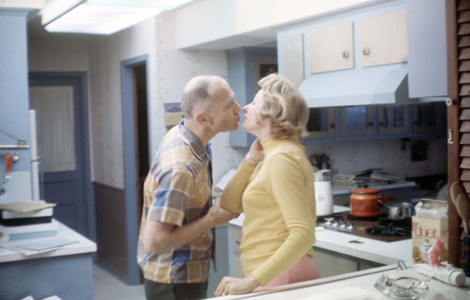 A tender moment—Buzz Aldrin and his wife Joan share a kiss in their Texas kitchen before his journey to the stars.