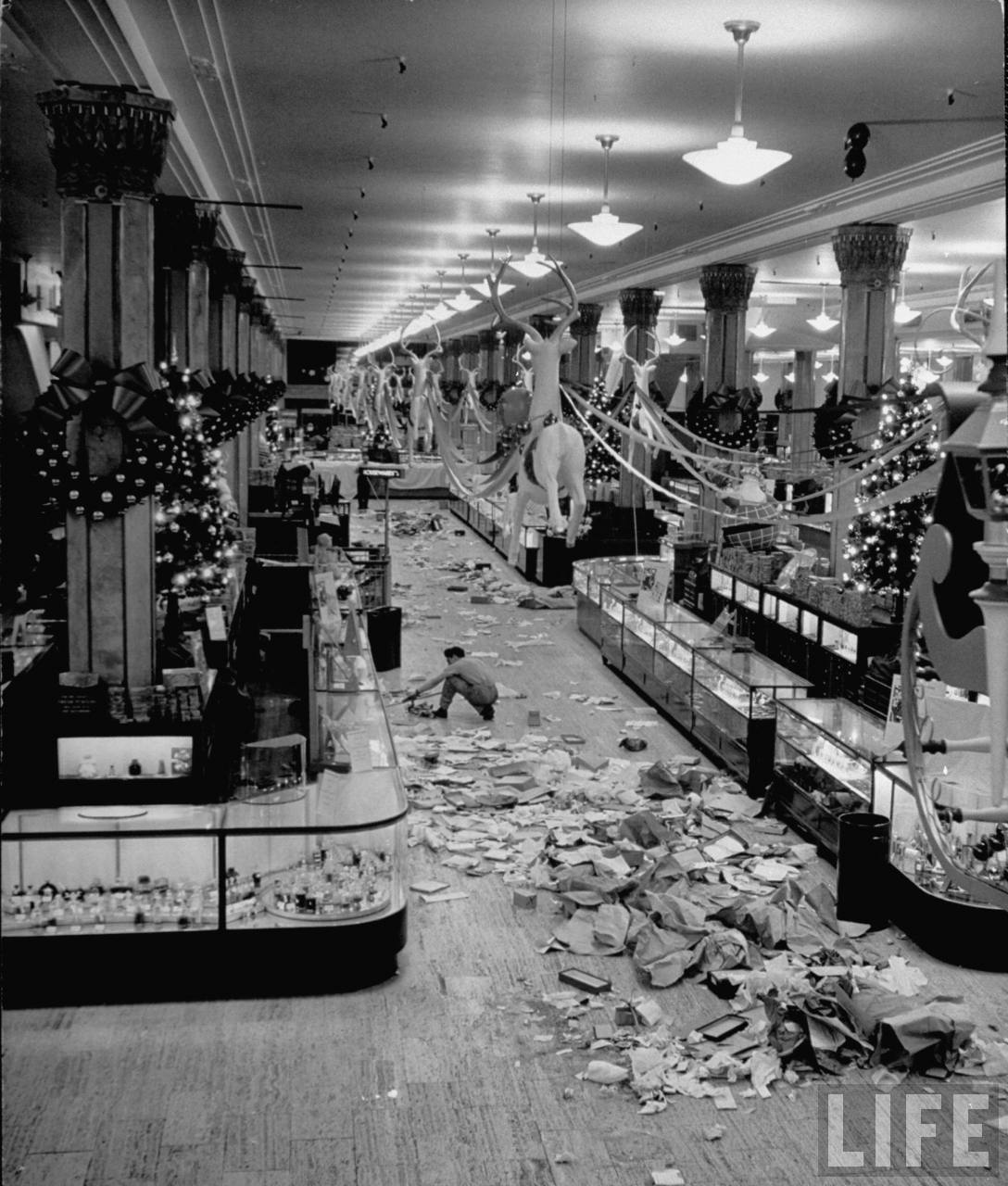 After the holiday rush, a Macy’s employee cleans up the mess left behind in the store.