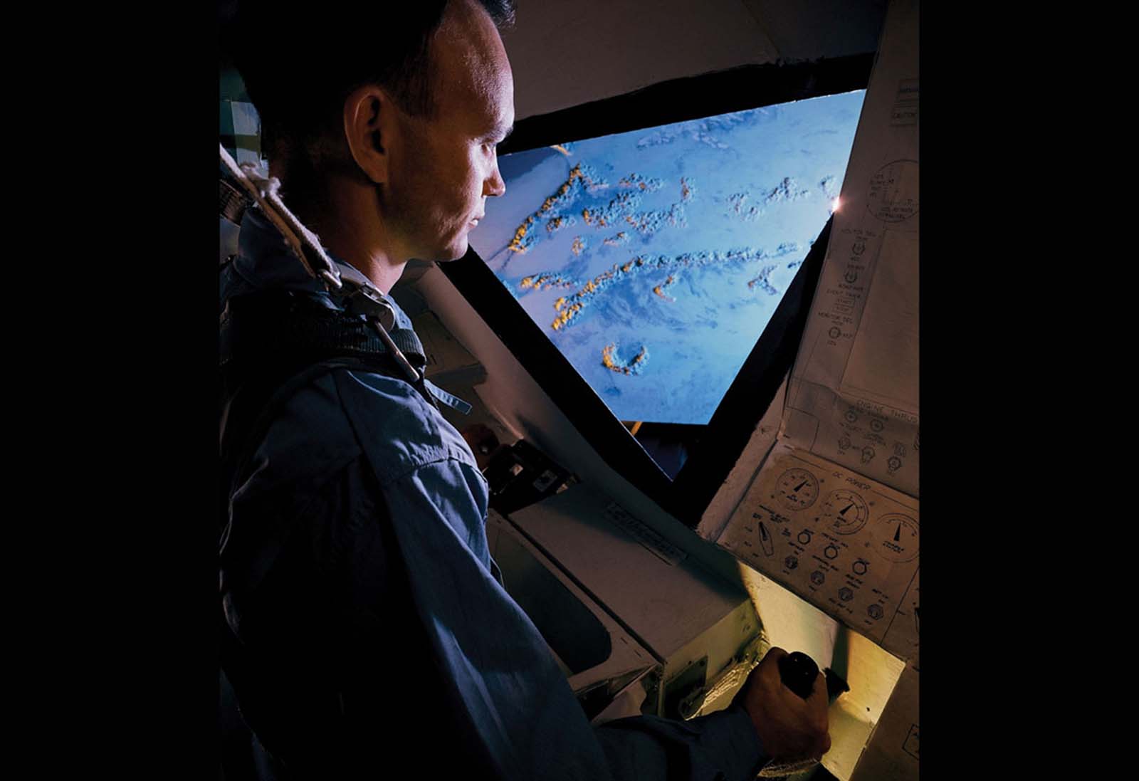 An Apollo astronaut refines his skills inside a flight simulator, preparing for the challenges of space travel.