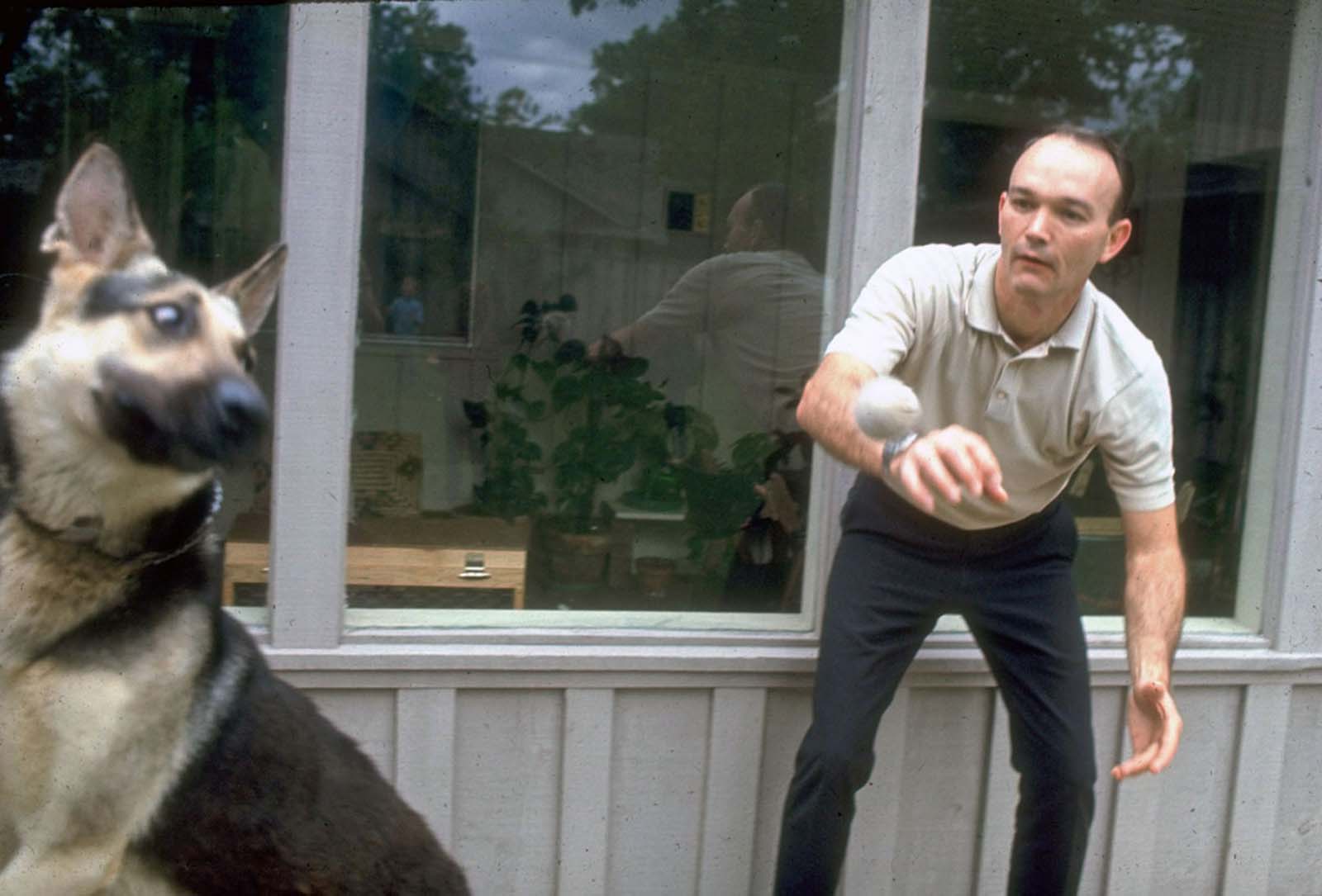 Apollo 11’s Michael Collins shares a quiet moment with his loyal dog, a rare respite before launch.