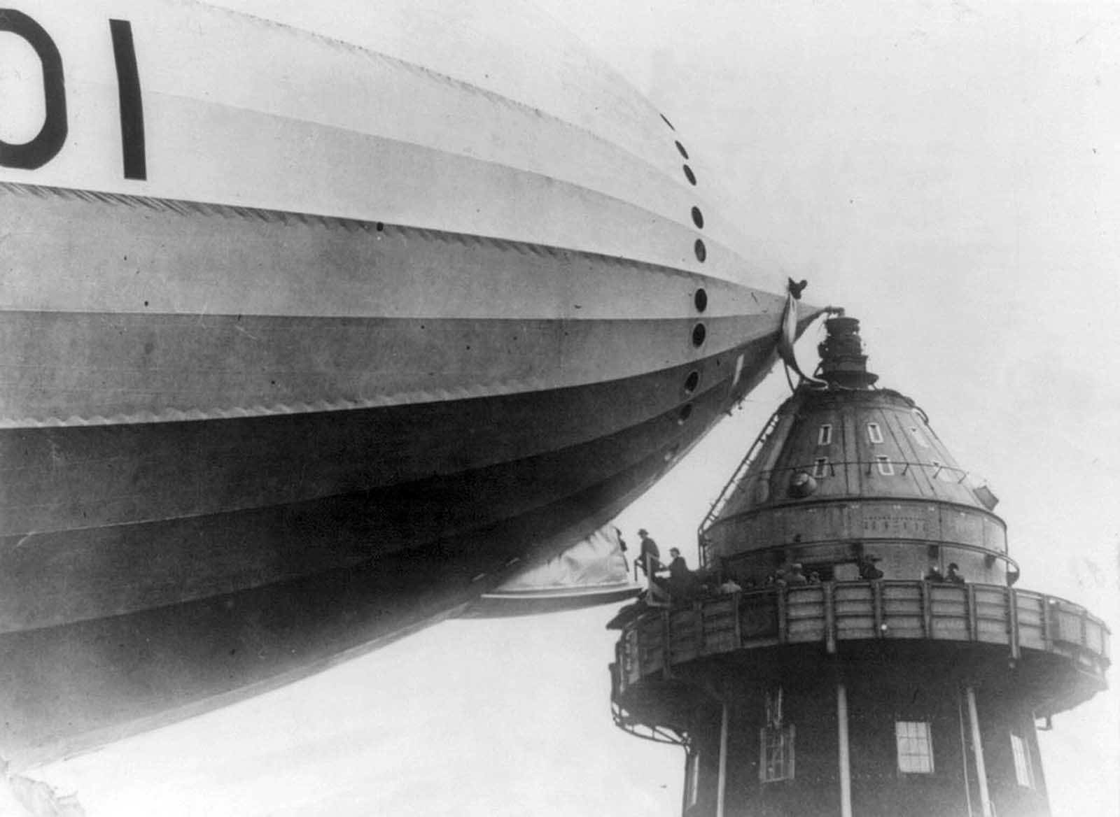 British Members of Parliament step onto an airship gangplank in Cardington, England, during the 1920s.