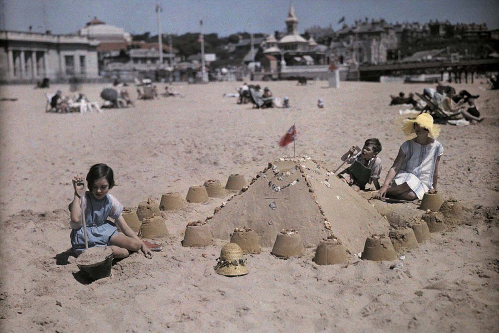 Building Sandcastles by the Sea – A family enjoys a summer day at Sandbourne Beach, near Bournemouth, Dorset.