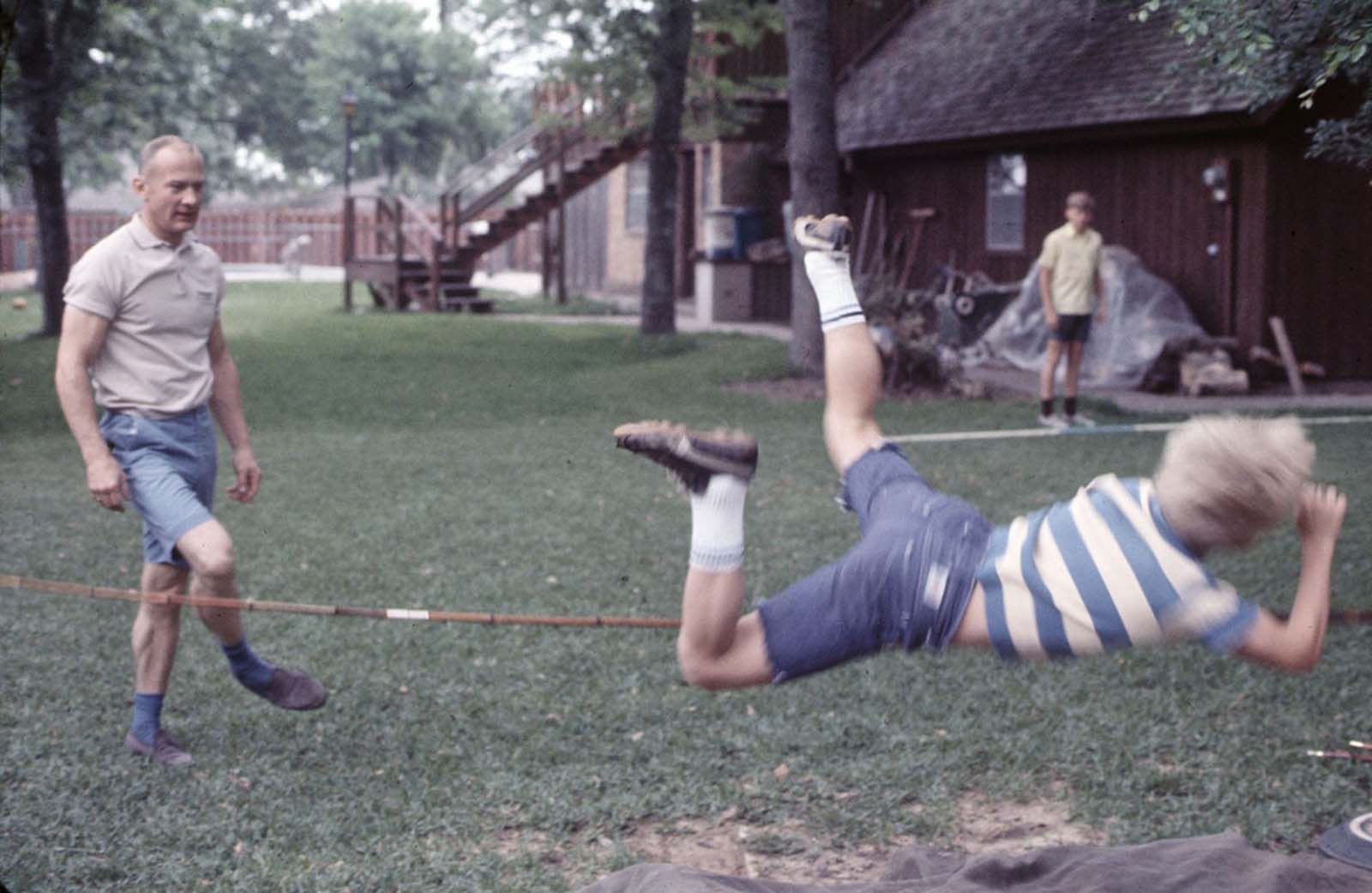 Buzz Aldrin and his sons enjoy an afternoon of pole vaulting, showcasing the lighter side of a future moonwalker.