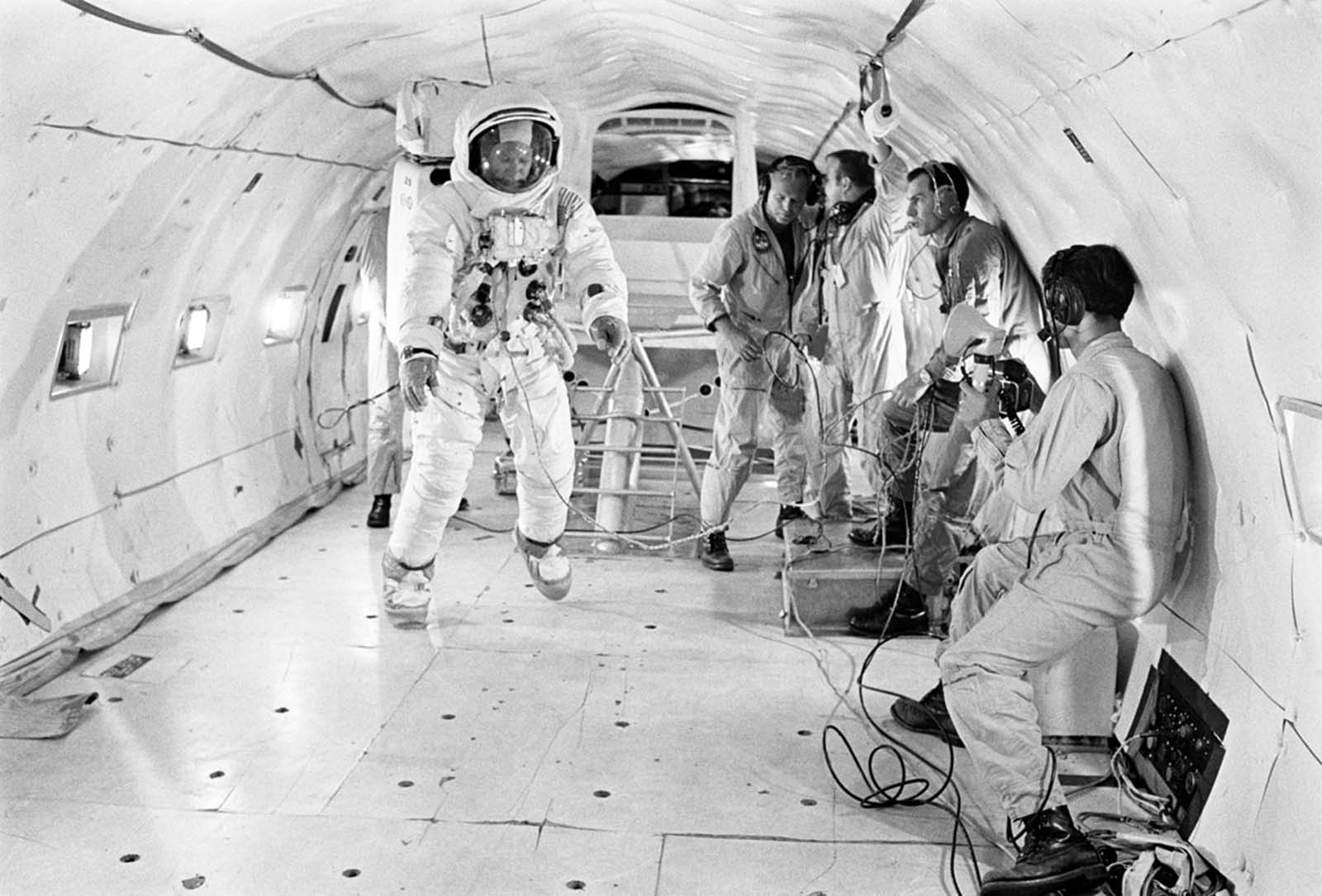 Buzz Aldrin floats in a partially weightless environment aboard a KC-135 aircraft, simulating the moon’s one-sixth gravity, July 9, 1969.