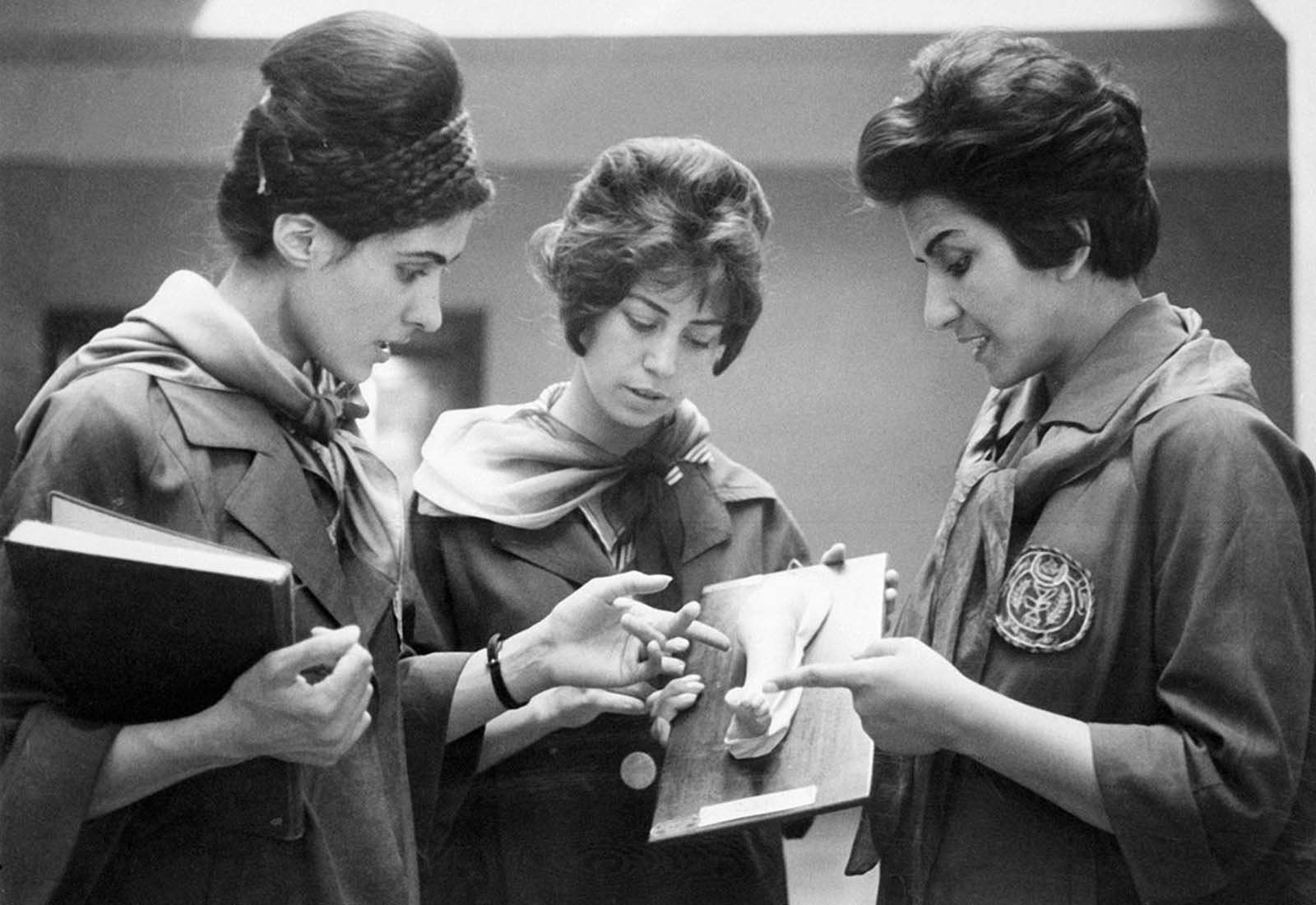 Captured in 1962, two Afghan medical students attentively listen to their professor at the Faculty of Medicine in Kabul.
