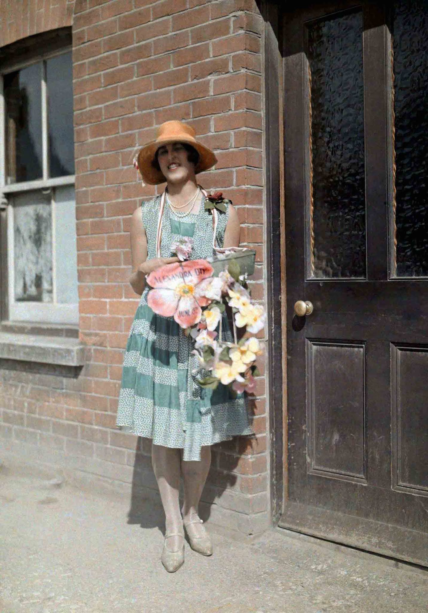 Charity and Tradition – A young girl sells artificial flowers for Alexandra Rose Day in Kent, a charitable tradition that began in 1912 to honor Queen Alexandra.