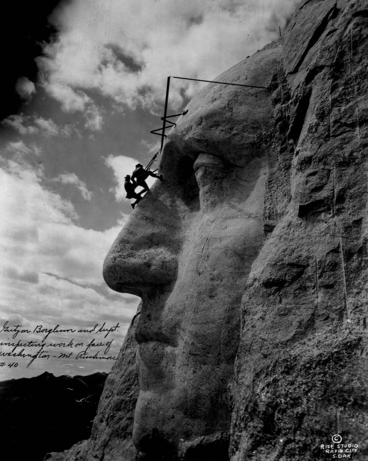 Gutzon Borglum and another sculptor hang from George Washington’s forehead, 1932.