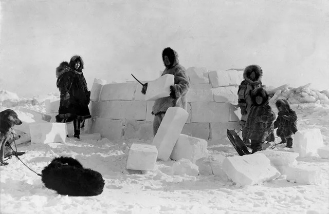 In 1924, an Inuit family works together to build an igloo in Alaska.