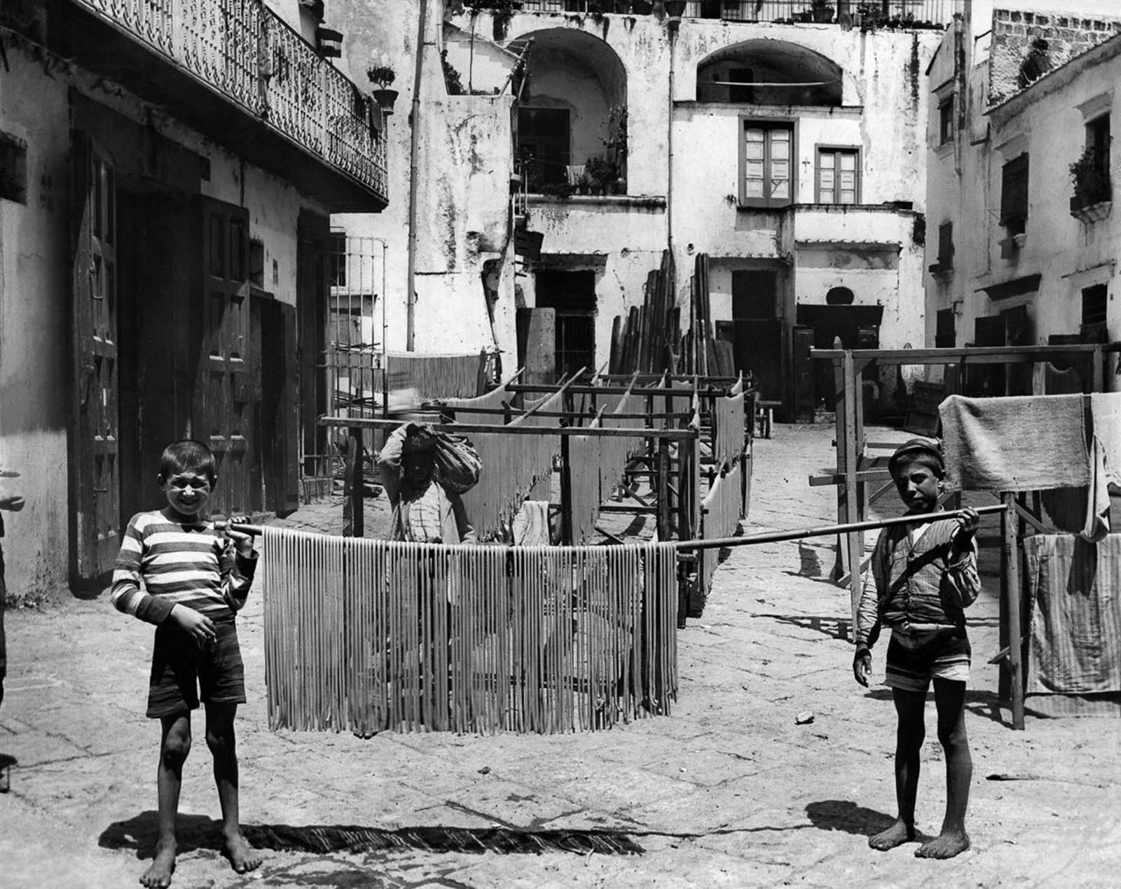 Italian boys proudly display drying pasta, showcasing the country’s deep culinary heritage. 1928.