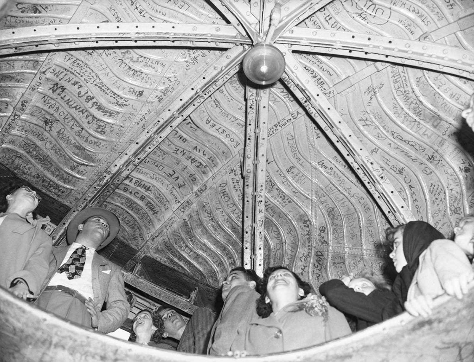 June 20, 1946—A visitor to the Statue of Liberty writes his and his wife’s names on an interior girder, joining the tradition of leaving a mark on Miss Liberty.