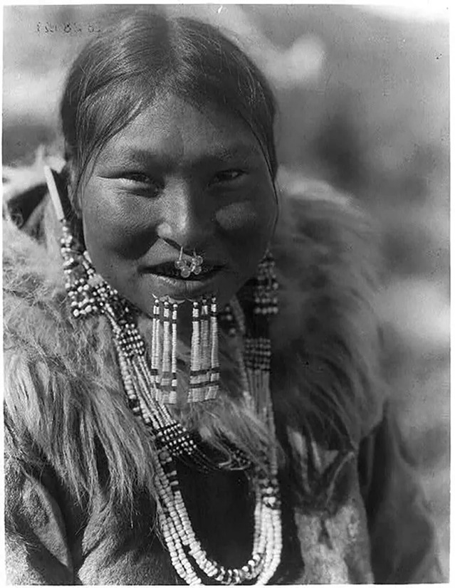 Kenowun, an Inuit woman from Nunivak Island, Alaska, poses wearing beautiful jewelry on February 28, 1929.