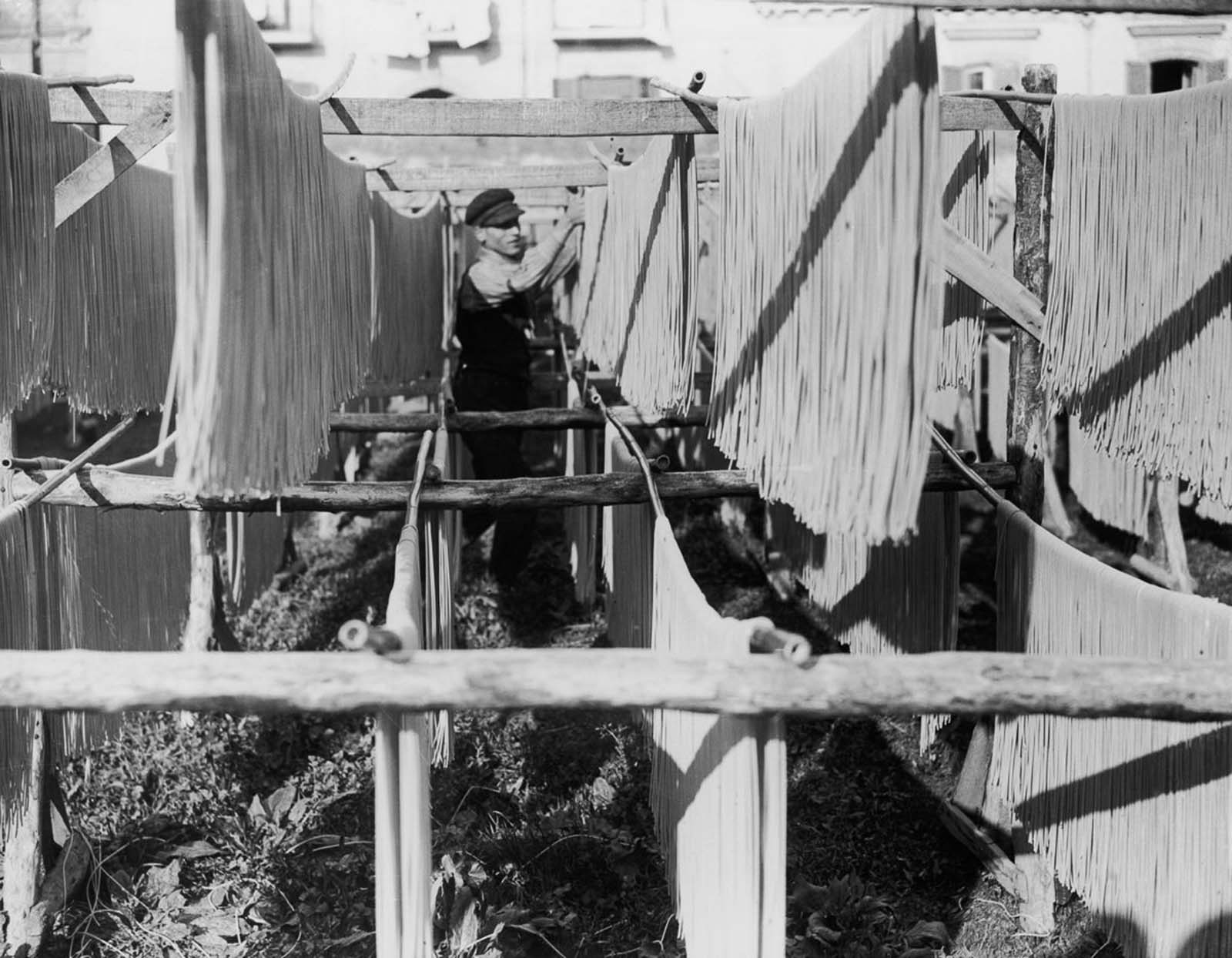 Long racks of pasta left to dry under the Mediterranean sun at a Naples factory. 1925.