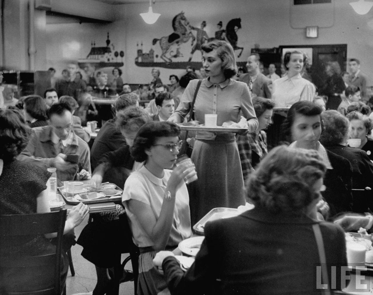 Macy’s employee Janet Steurer (C) scans the cafeteria for an empty seat amidst the bustling store atmosphere.