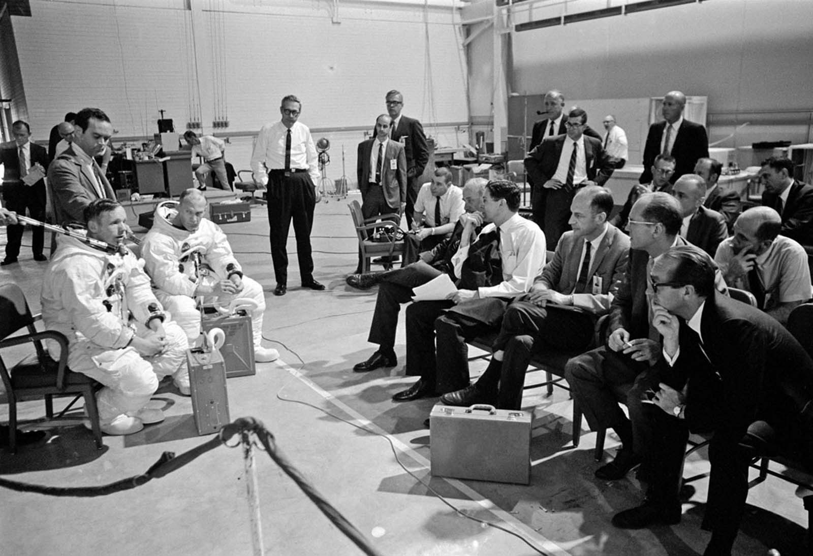 Neil Armstrong and Buzz Aldrin brief NASA officials on their “Lunar Timeline Demo,” refining mission protocols on April 22, 1969.