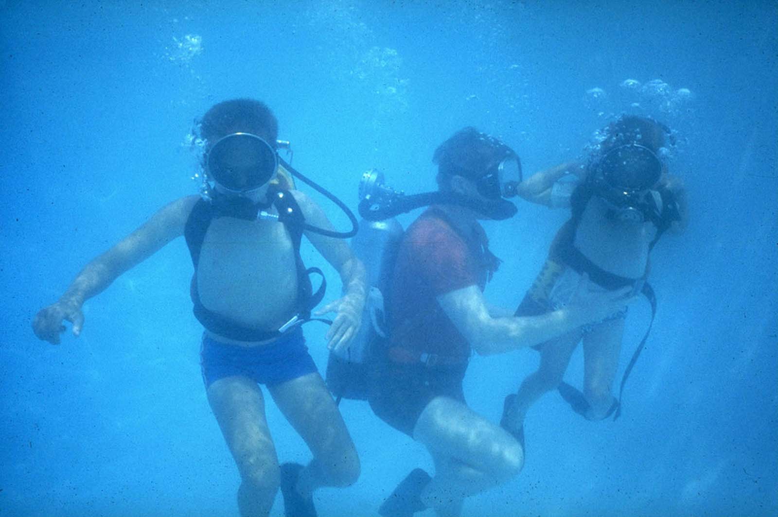 Neil Armstrong takes his sons Ricky and Mark scuba diving in a Houston swimming pool, proving an astronaut’s training isn’t all work and no play.