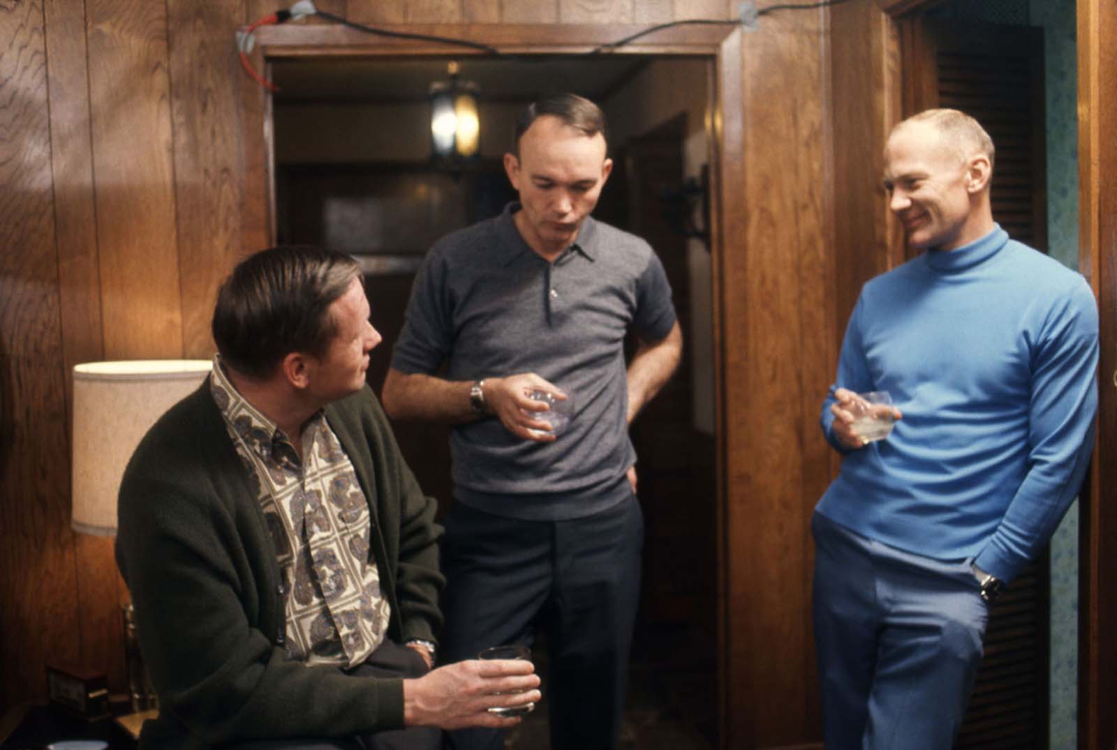 Over drinks in Houston, Neil Armstrong, Michael Collins, and Buzz Aldrin discuss their upcoming mission in March 1969.