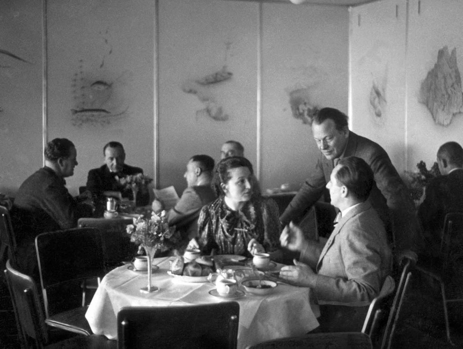 Passengers enjoy an elegant meal in the dining room of the Hindenburg in April 1936.