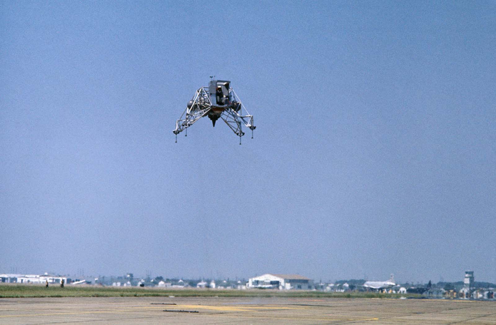 Practicing for the real thing—Commander Neil Armstrong pilots the Lunar Landing Training Vehicle at Ellington Air Force Base, simulating moon landings from 300 feet above ground.