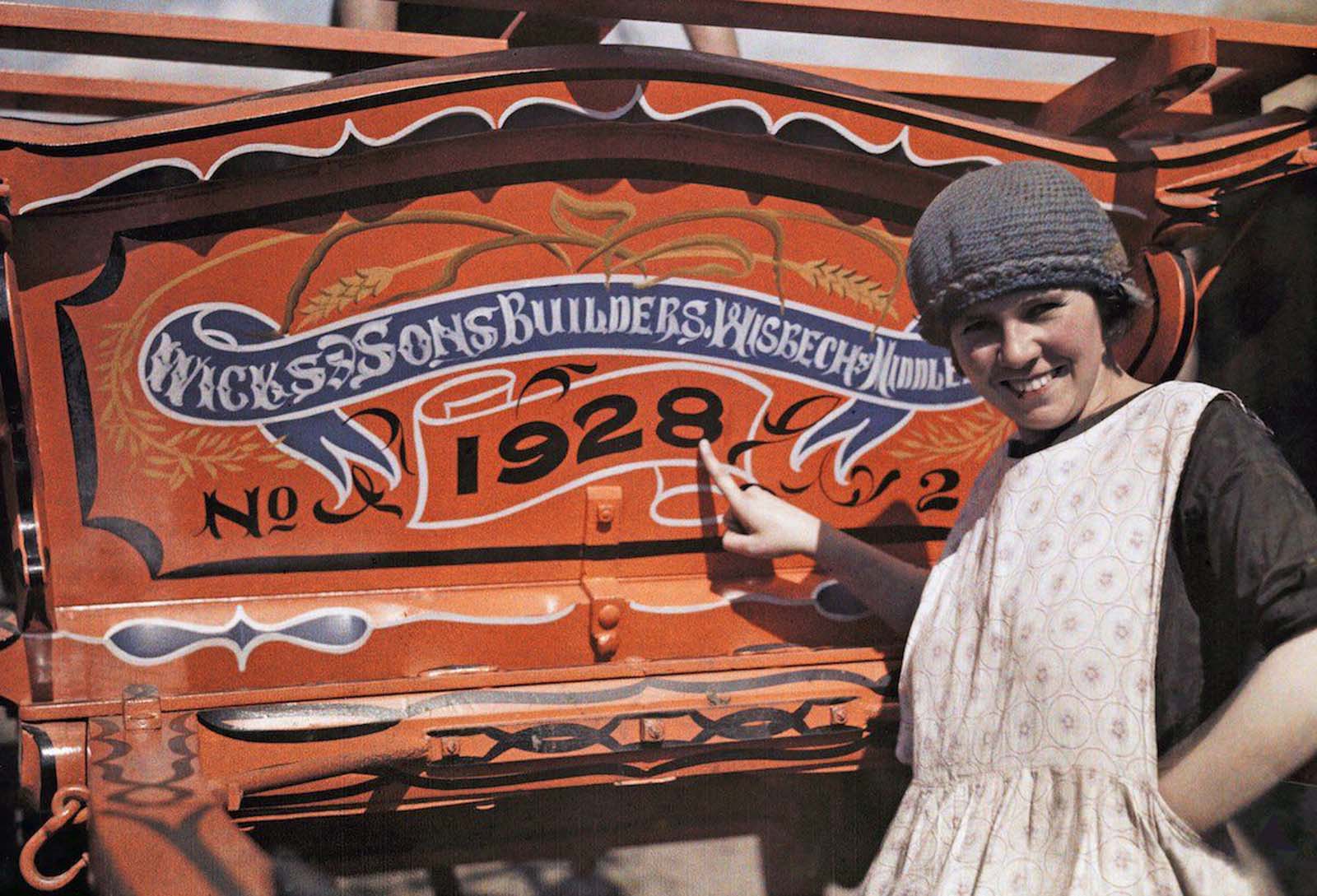 Pride in Tradition – A Cambridgeshire woman proudly showcases her farm cart, built by Wicks of Wisbech, which crafted the horse-drawn caravans used by Romany travelers across Britain.