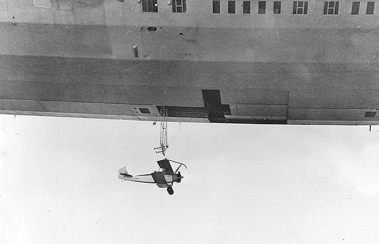 The USS Akron launches a Consolidated N2Y-1 training plane during a test flight near Naval Air Station Lakehurst, New Jersey, on May 4, 1932.