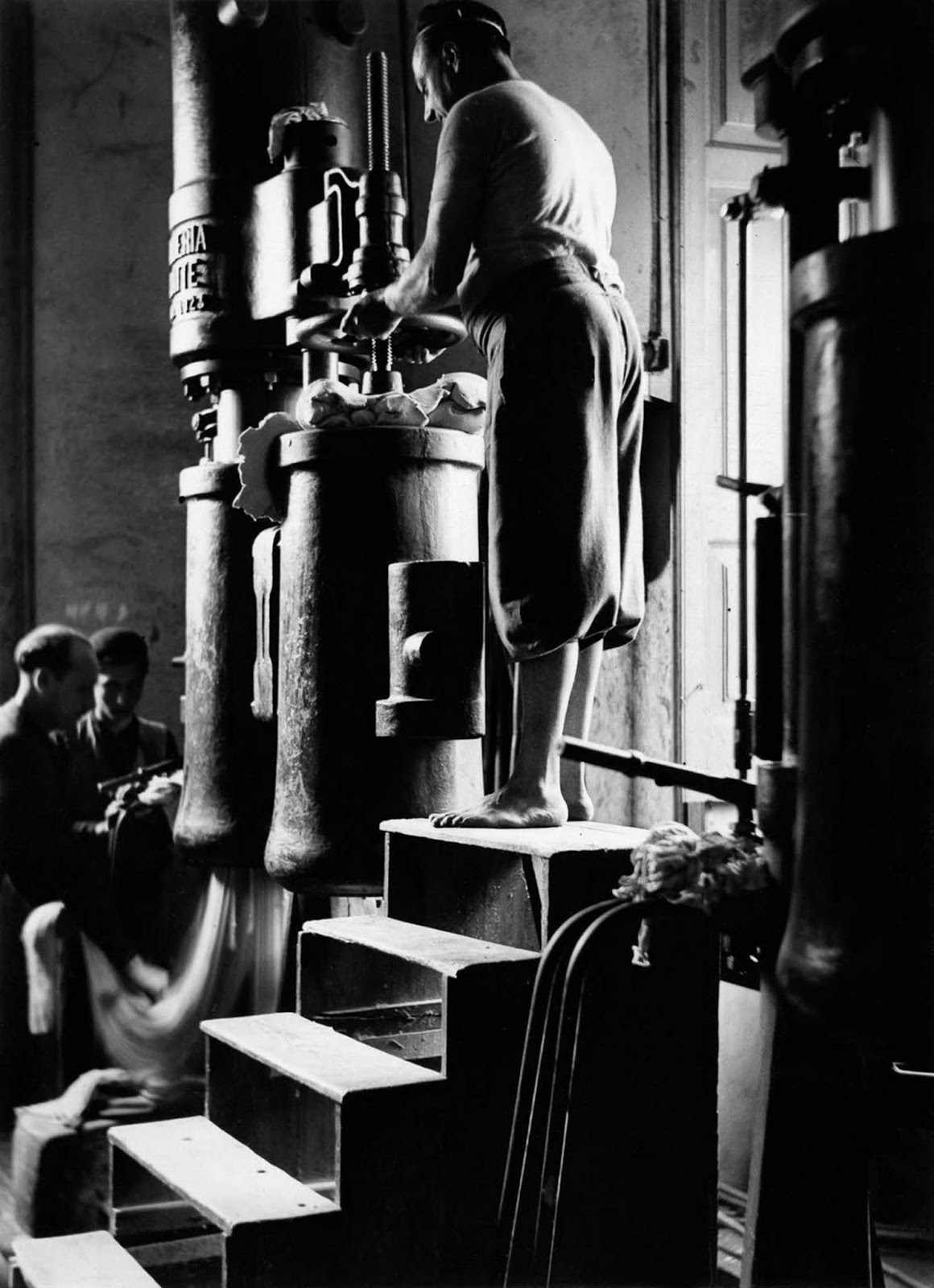 The art of pasta-making begins—workers prepare the dough by hand. 1932.