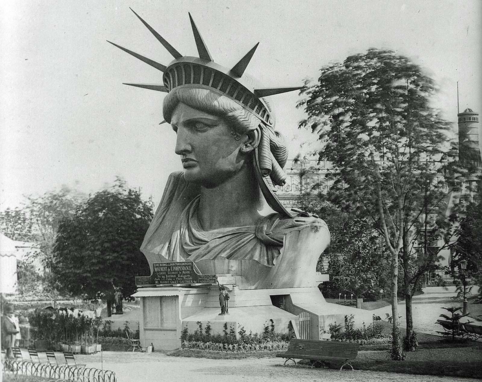 The colossal head of the Statue of Liberty on public display in a Paris park, 1883, before its journey to the United States.