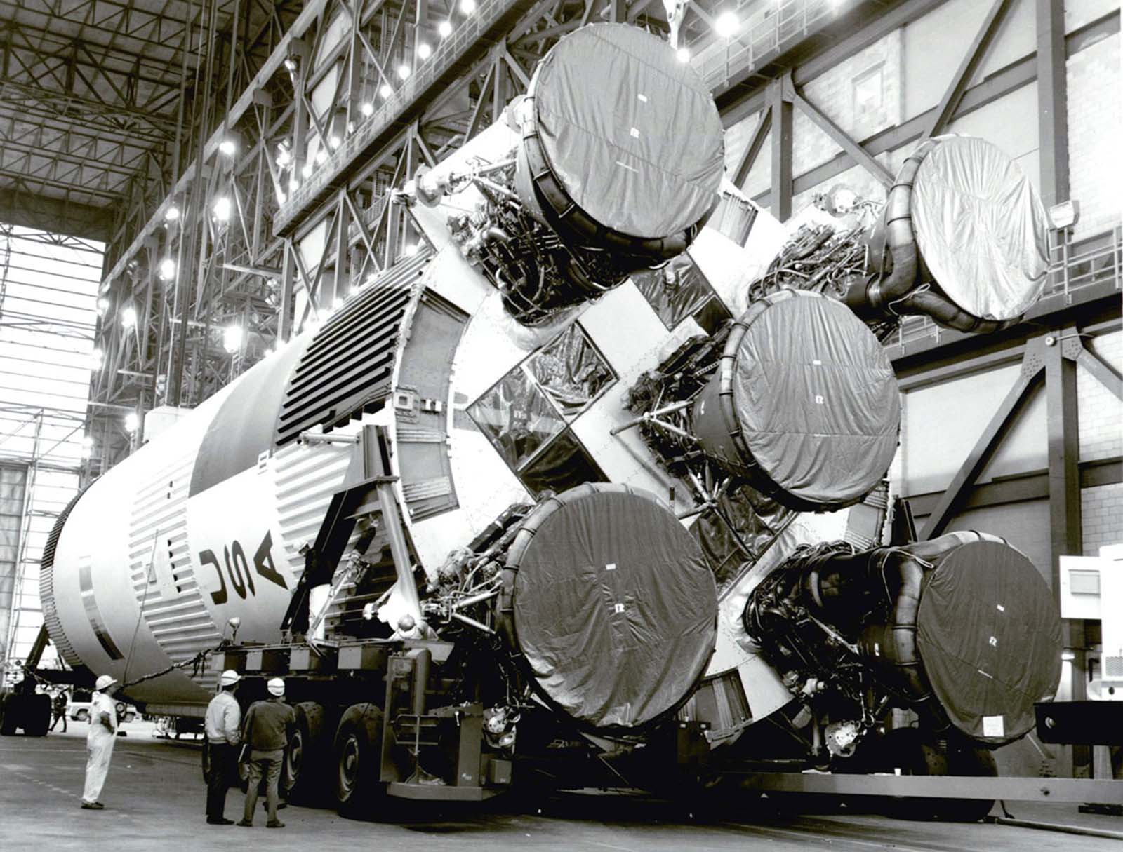 The towering S-1C booster for Apollo 11’s Saturn V rocket awaits assembly inside NASA’s Vehicle Assembly Building at Kennedy Space Center, February 21, 1969.