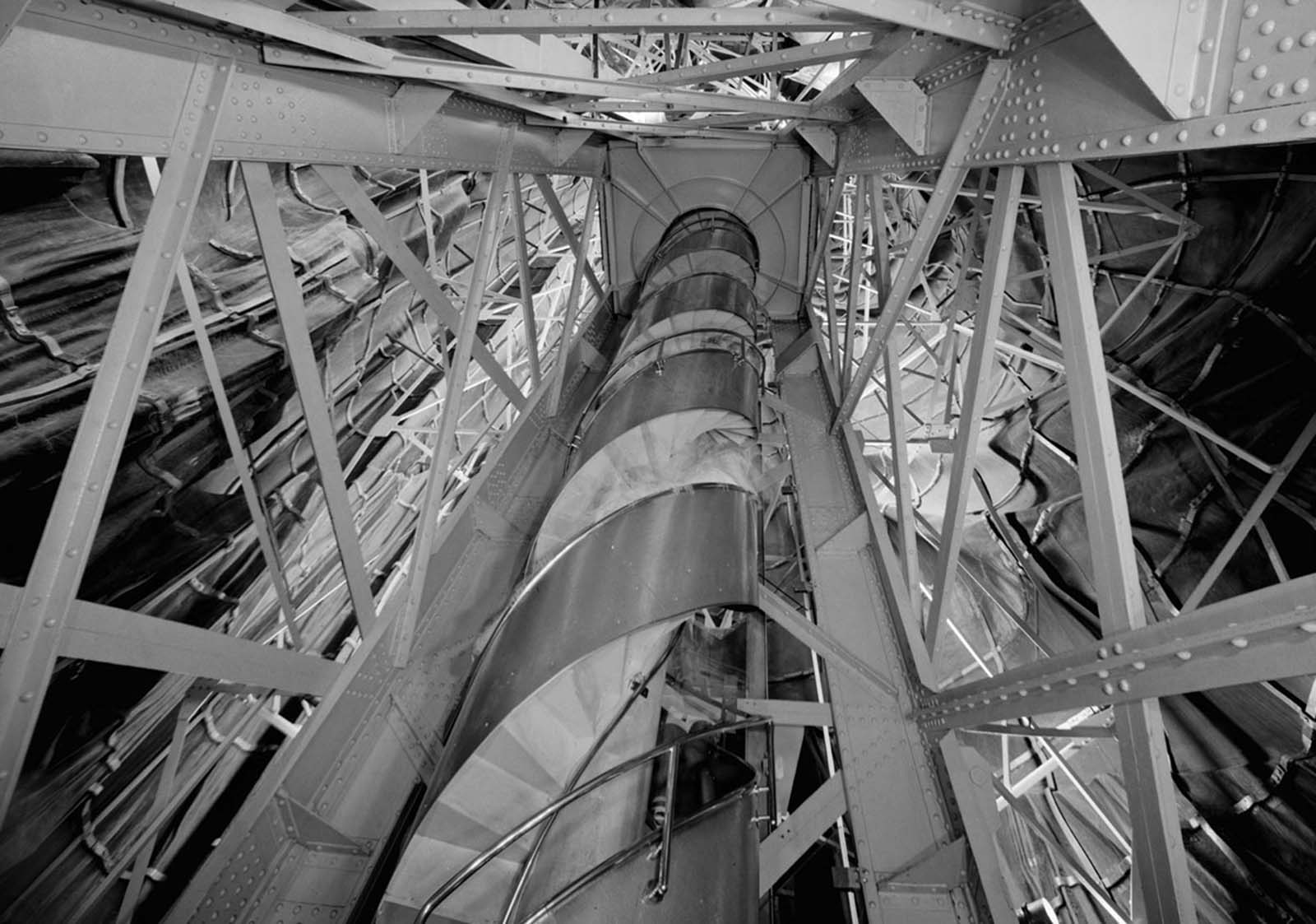 The winding spiral staircase inside the Statue of Liberty, leading visitors toward the crown and its breathtaking views.