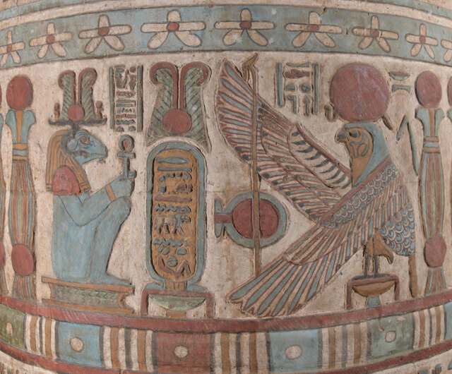A painted relief on a column within the hall displays an oval cartouche with the name of Emperor Hadrian (A.D. 117–138), flanked by Khnum, depicted as a ram, and Behedety, the falcon god of the midday sun.